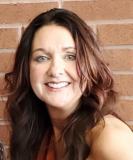 Profile picture of Marcine by a brick wall